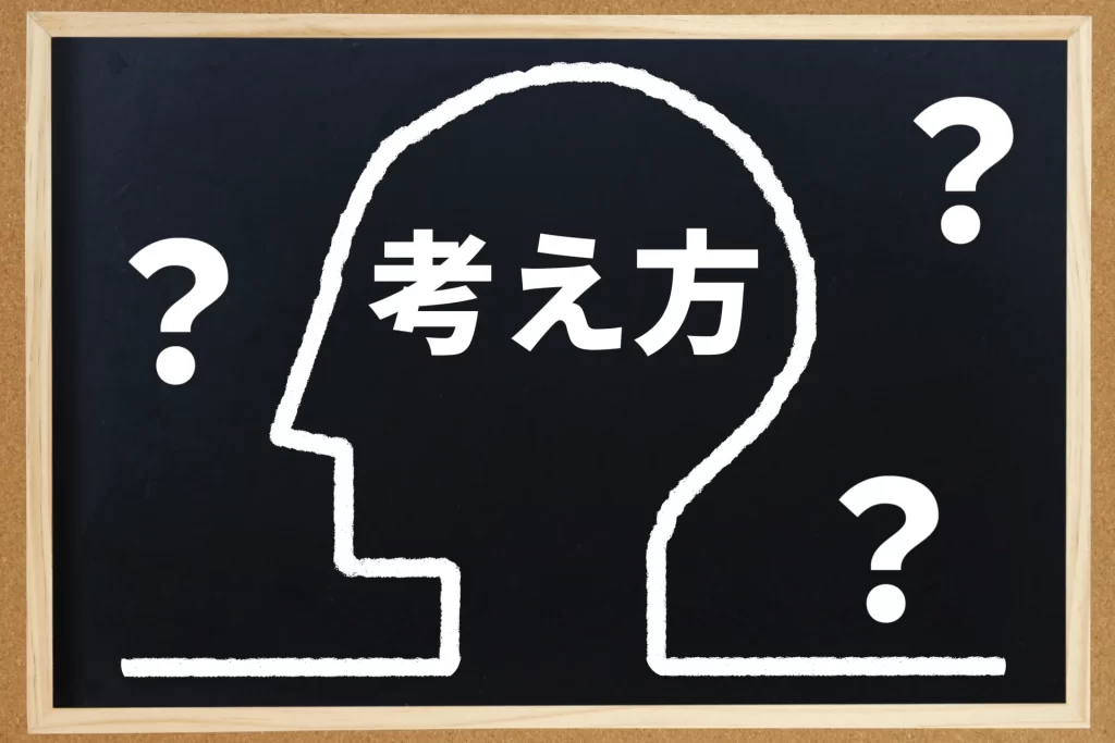 自分の考え方や認知行動療法の適応について悩む様子を表現した、思考と疑問符の黒板アート風画像